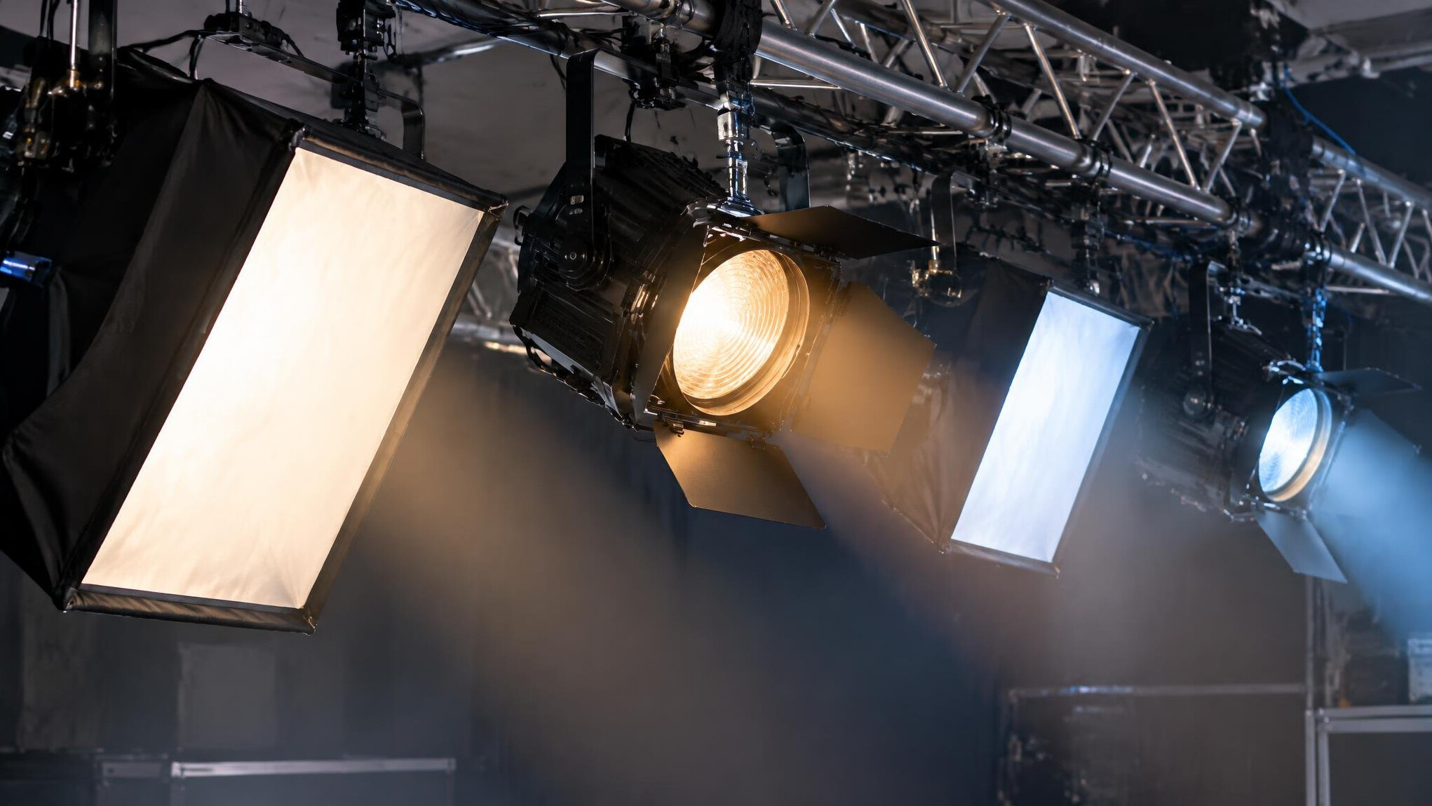 Close-up of studio lighting fixtures and softboxes rigged on a truss